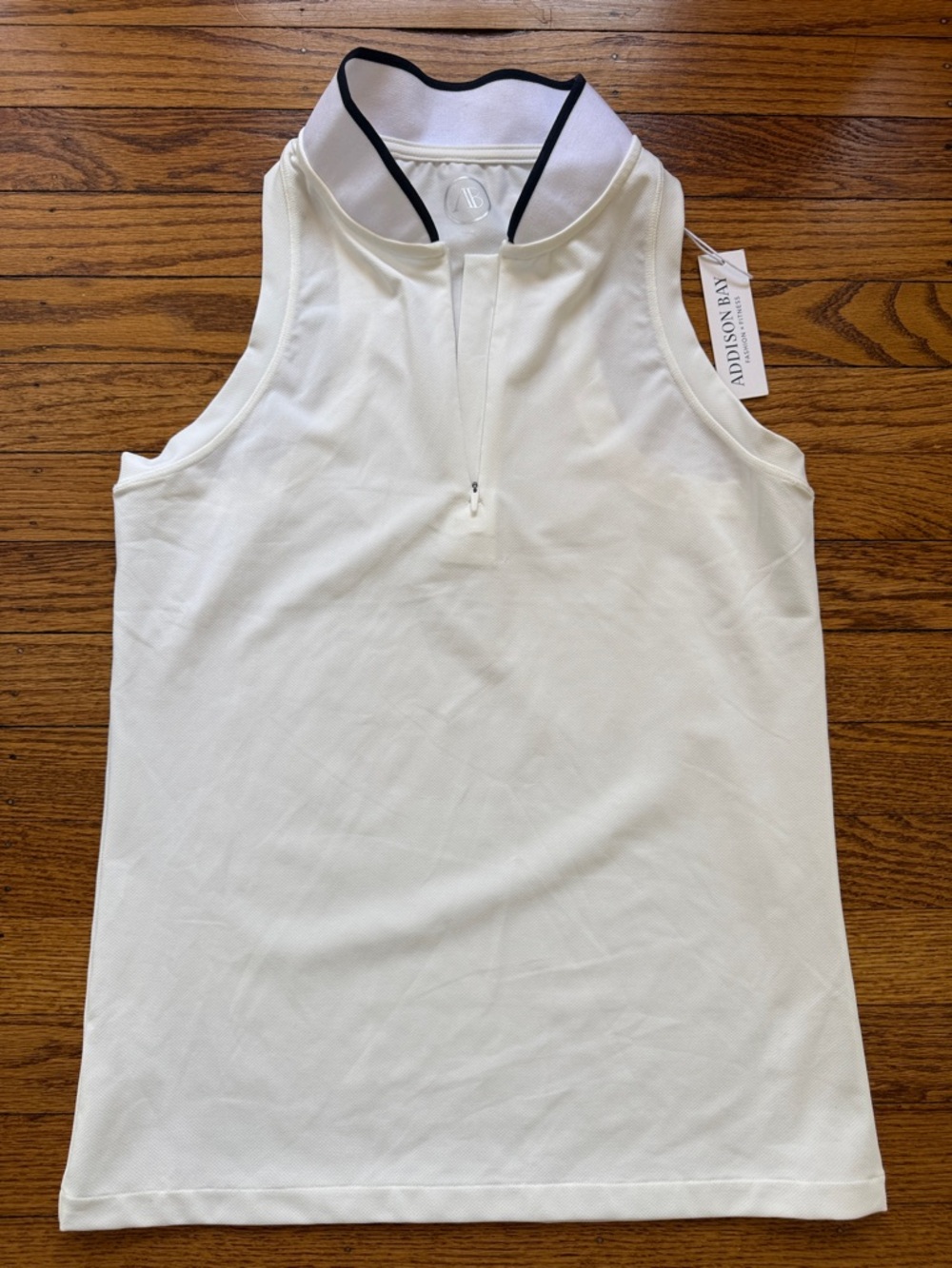 Addison Bay Cream Sleeveless Golf Polo Top with white collar black trim